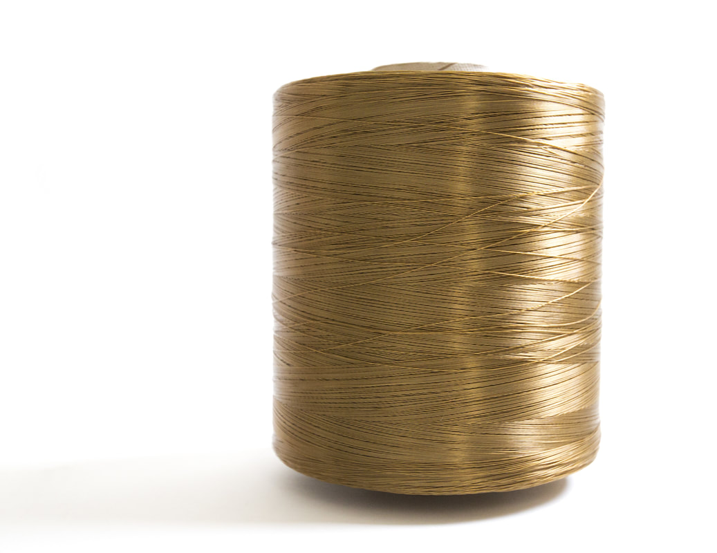 Twitchell gold spool of yarn on a white background